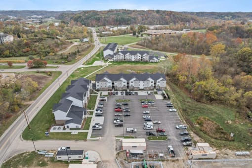 an aerial view of a parking lot with cars and buildings