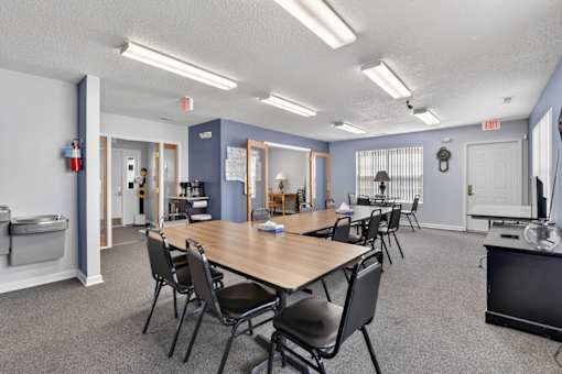 A conference room with a long table and chairs.