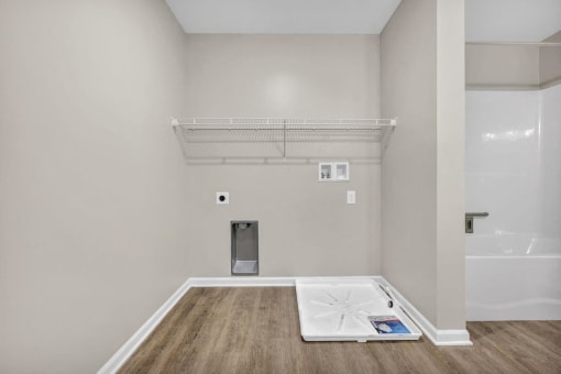 a white room with a white floor and a white bath tub