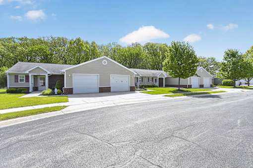 A row of houses with a cracked road in front.