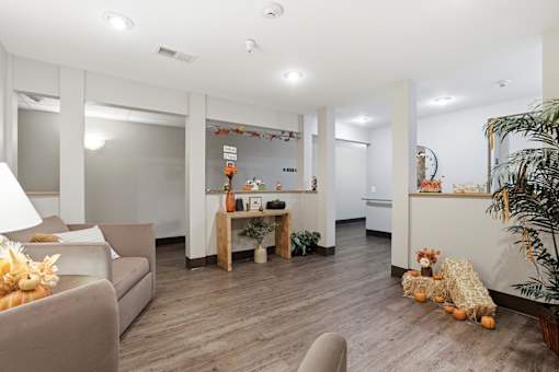 A living room with a grey couch and a wooden table.
