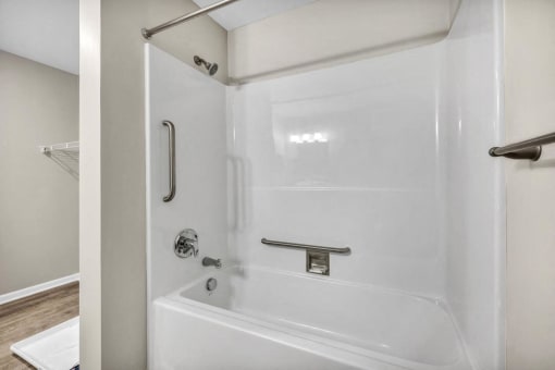 a white bathroom with a shower and a tub