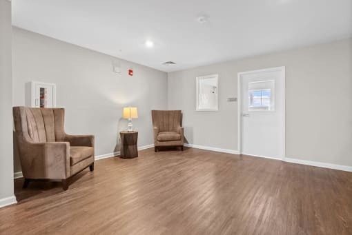 a living room with white walls and a wooden floor