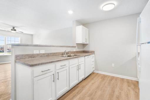a kitchen with white cabinets and a counter top