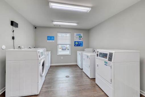 laundry room with washers and dryers at the preserve at great pond apartments in windsor