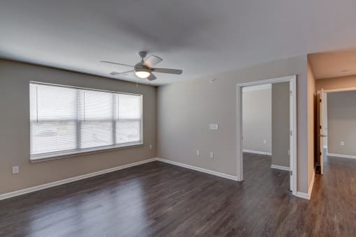 a bedroom with hardwood floors and a ceiling fan