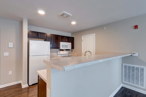 a kitchen with a large island and white appliances