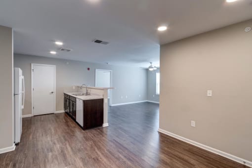 the kitchen and living room in a bedroom plus den unit.