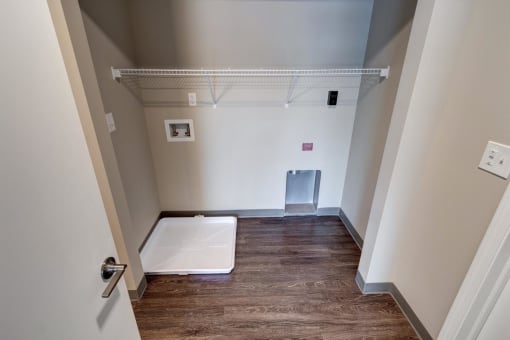 a bedroom with a medium sized closet and hardwood floors