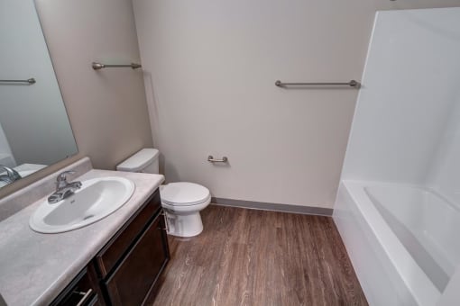 a bathroom with a toilet sink and bathtub in a 555 waverly unit