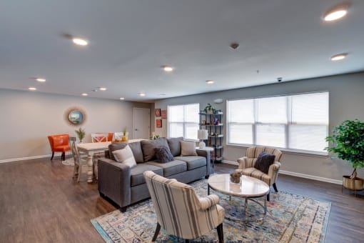 a living room with couches chairs and a table