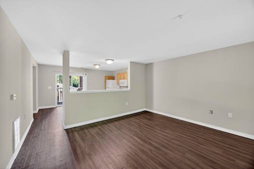 A room with wooden floors and white walls.