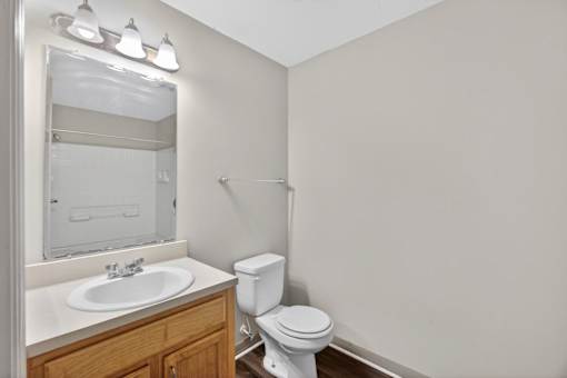 A white toilet sits next to a sink in a small bathroom.