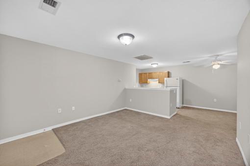 A room with a white ceiling and a carpeted floor.