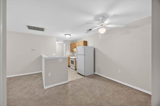 A kitchen area with a refrigerator, microwave, and oven.