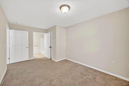 A room with carpeted floor and white walls.