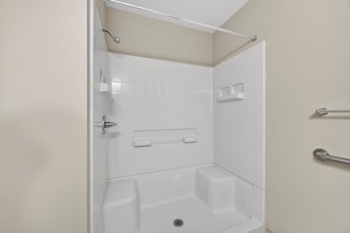 A white bathroom with a walk in shower.