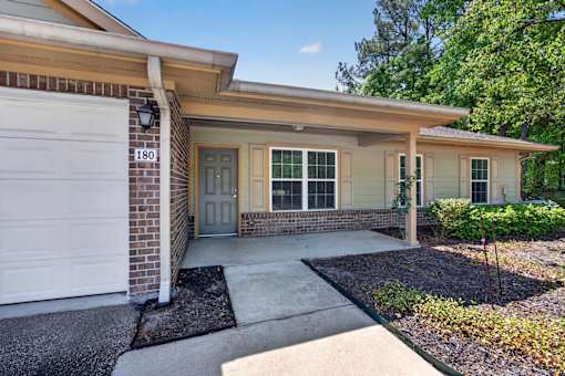 A house with a garage door numbered 180 is shown.