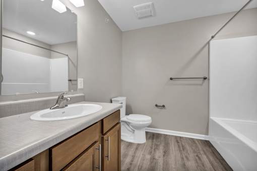 A bathroom with a white sink, toilet, and bathtub.