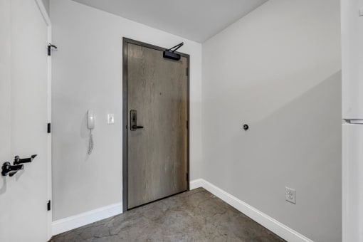 a bedroom with a medium sized bed and a refrigerator in a room