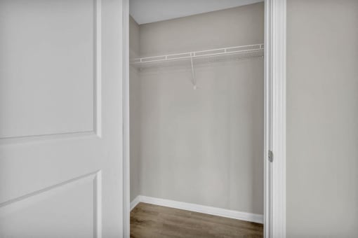 the closet in a bedroom with white walls and a white