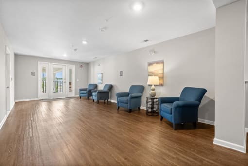 a living room with white walls and a hardwood floor
