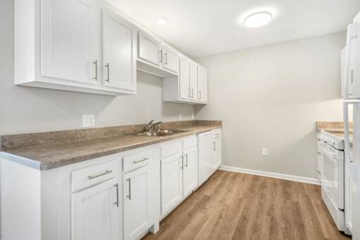 a white kitchen with white cabinets and white appliances
