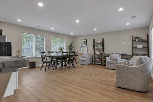A living room with a wooden floor and a large window.