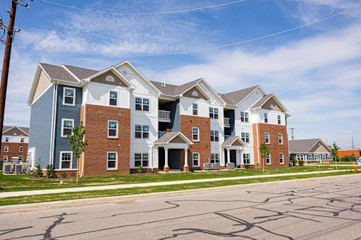 A row of houses with a blue sky in the background.