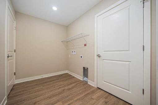 A room with a white door and a small white shelf above it.