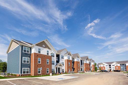 A row of modern apartment buildings with a clear blue sky above.