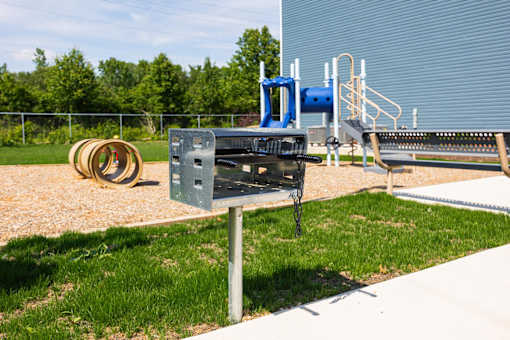 A playground with a slide and a swing set.