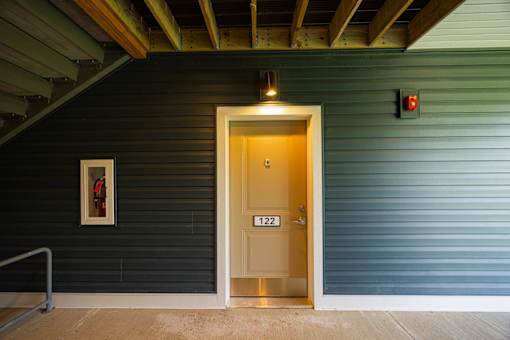 A door with the number 1221 on it is the only entrance to a building.