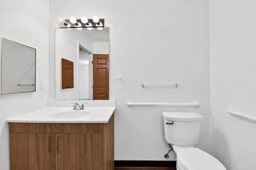 A white toilet sits next to a sink in a bathroom.