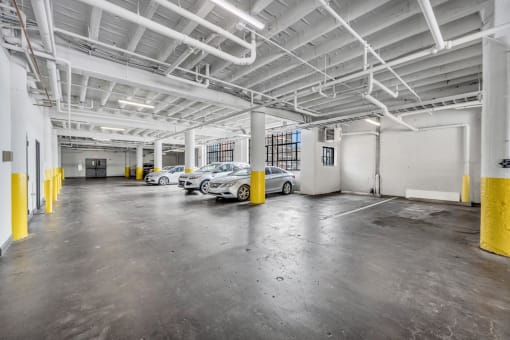 a parking garage with several cars in it