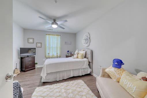 a bedroom with two beds and a ceiling fan