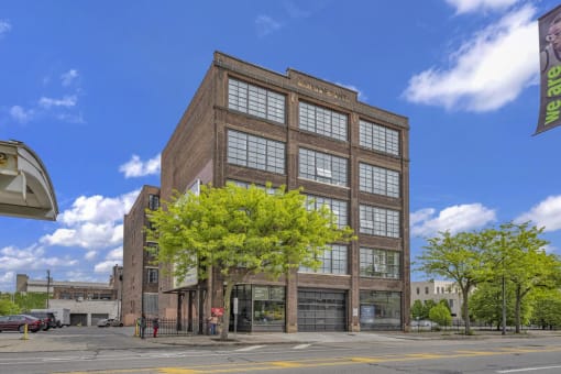 a large brick building with a tree in front of it