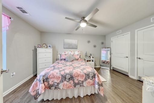a bedroom with a bed and a ceiling fan