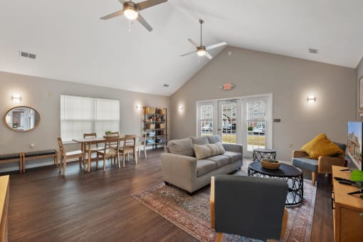 a living room with a couch and a table and a ceiling fan