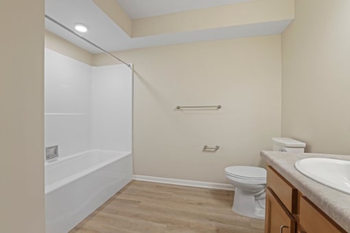 a bathroom with a shower and a toilet and a sink