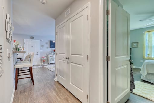 a bedroom with a bed and a desk in a room