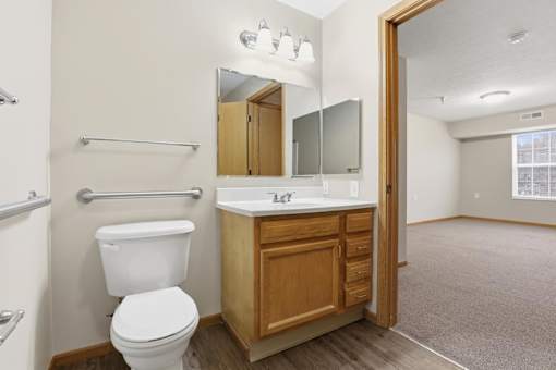 A white toilet sits next to a sink in a small bathroom.