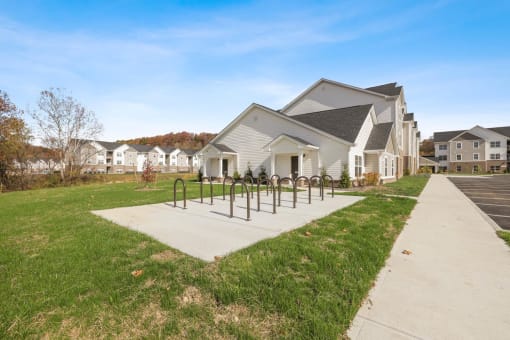 a view of a house with a fence in front of it and a yard with