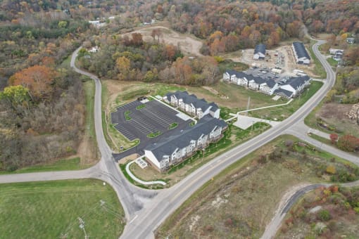 an aerial view of a school with a road and some buildings
