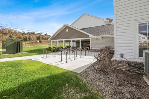 the front of a house with a patio and a bike rack