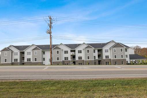 a row of apartment buildings on the side of a road