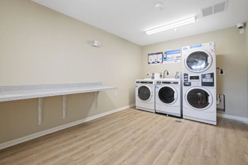 a washer and dryer in a laundry room with a counter