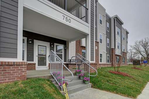 The front entrance of apartment 750 in a grey building.