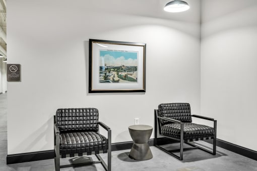 a seating area with two chairs and a coffee table