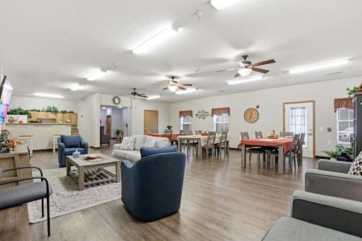 A living room with a dining table and chairs.